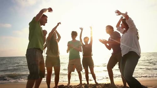 Multiracial Group Dancing at Beach
