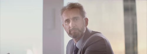 Confident Businessman Smiling in a Modern Office