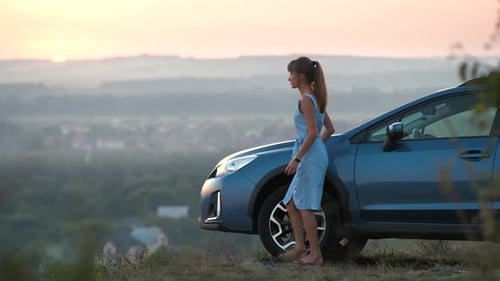 Woman Enjoying Scenic Vista at Sunrise by Car