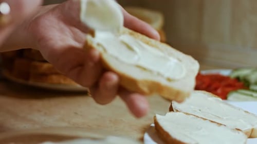 Hands Spread Mayonnaise on Bread Butter