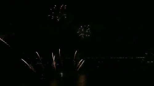 Fireworks Display Over the Water at Night