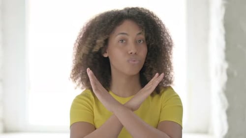 Woman Gesturing No with Crossed Arms and Headshake