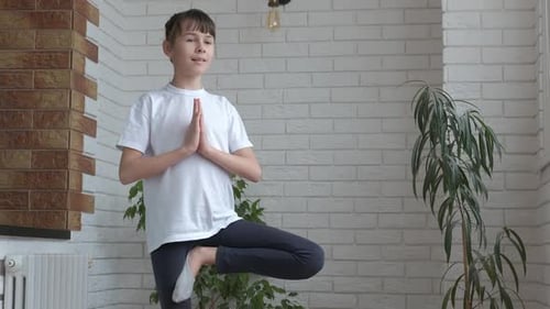 Girl Doing Yoga Tree Pose at Home