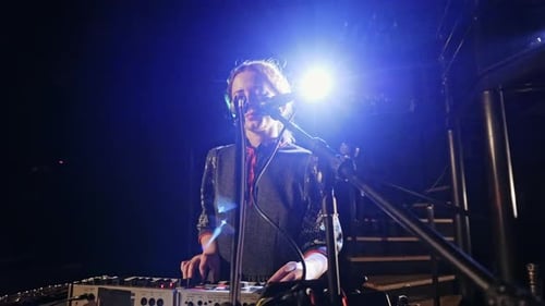 Woman Sings and Plays Keyboard on Stage