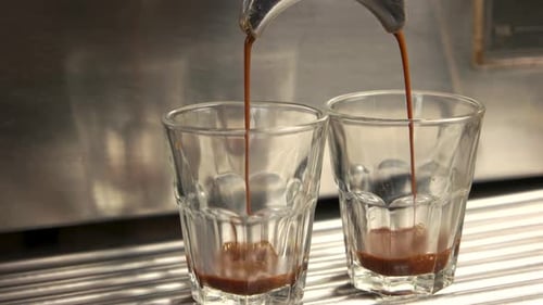 Espresso Pours into Glasses from Machine