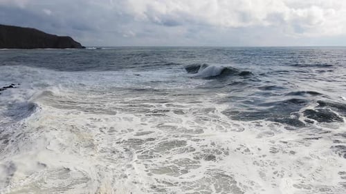 Crashing Waves on Rocky Coastline from Above