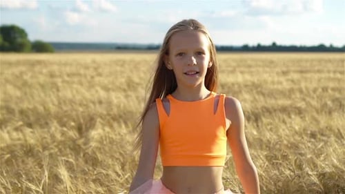 Adorable Preschooler Girl Walking Happily in Wheat Field on Warm and Sunny Summer Day
