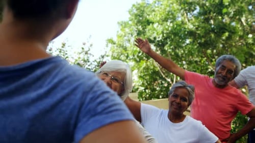 Senior Adults Exercise Together in the Park