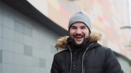 Handsome guy surprised by the camera opens his mouth in delight, emotions of happiness triumph on th