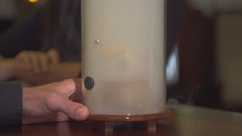 A man and woman couple having a very cold drink at a bar at a tropical island resort