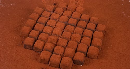 Delicious Chocolate Truffles with Cocoa Powder Falling