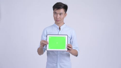 Young Adult Holding Tablet with Green Screen