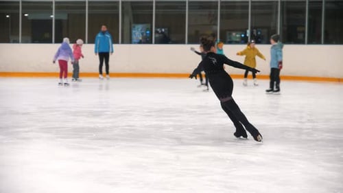 Child Figure Skating on Ice at Indoor Rink