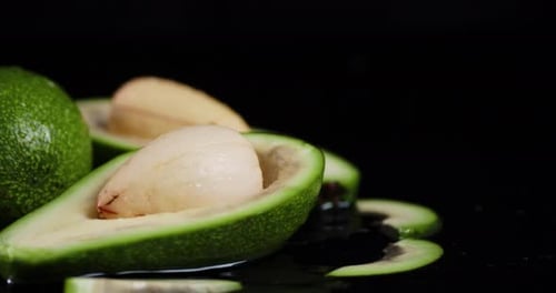 Falling Cut Fresh Avocados in the Water.