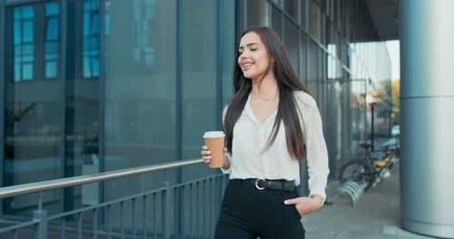 Beautiful Cheerful Woman Working in an Office Corporation Company Dressed in Elegant Clothes Walks