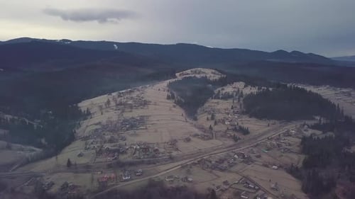 Flight Over the Village in the Carpathian Mountains