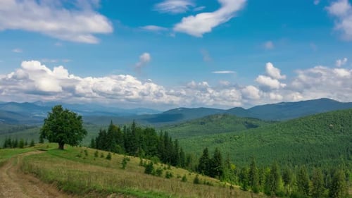 Foggy Mountain Landscape with a Fast Fluffy Clouds and Shadows.