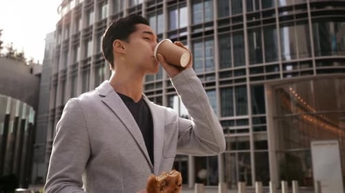 Young Man Enjoys Lunch Break in Urban Setting