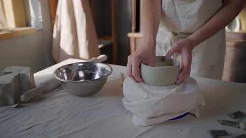 Hands Shaping Clay Bowl in Home Studio