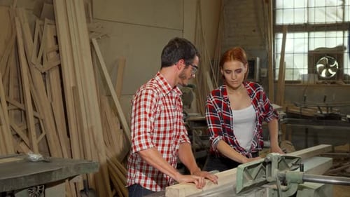 Man and Woman Working with Wood in Woodshop
