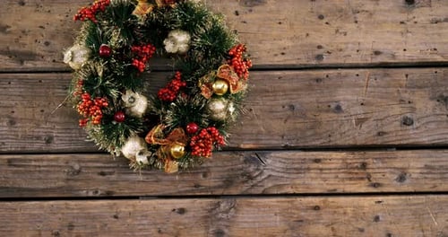 Festive Christmas Wreath Hanging on Rustic Wood Wall
