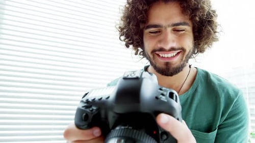 Happy Young Adult with Camera Smiling