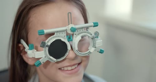 Schoolgirl Girl in a Bright Modern Optometrist's Office