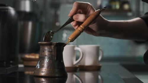 Adding Coffee Grounds to a Copper Coffee Pot