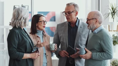 Group of Mixed-Aged Office Workers Having Discussion