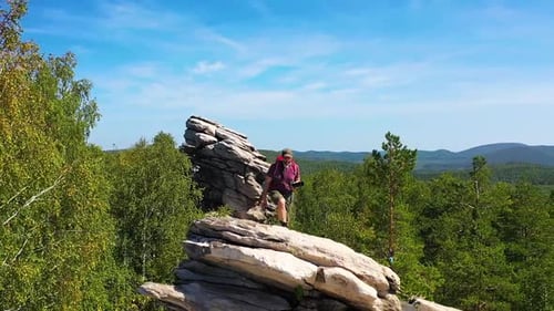 View of a Tourist Photographer Climbed to the Top of the Mountain to Take a Photo