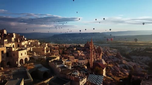 Drone Footage of Ancient Town Cappadocia with Houses on Mountain and Vehicles Flying in Sky