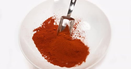 Paprika, capsicum annuum, Powder falling against White Background, Slow Motion 4K