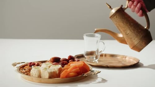 Turkish Tea and Sweets Hot Drink in Traditional Armudu Glass Closeup