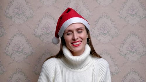 Smiling Woman Wearing a Red Santa Hat