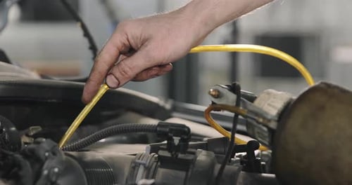 Mechanic Draining Old Brake Fluid From A System During The Service. Close Up