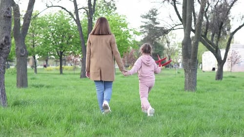 Mother and Child Walking in the Park