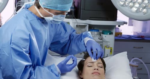 Surgeon Giving Injection to Patient in Operating Room