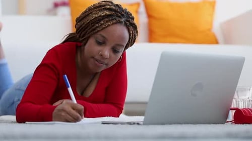 Woman Works on Laptop at Home