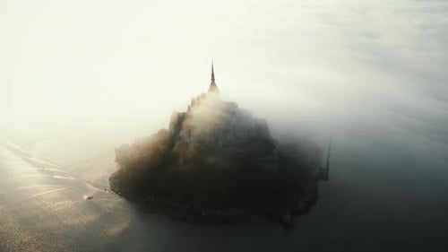 Epic Aerial Shot of Mont Saint Michel on High Tide Sunrise, Ancient Island Castle Covered By Sunny