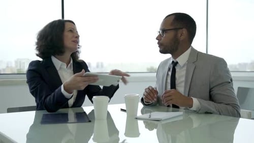 Slow Motion Shot of Two Colleagues Talking During Meeting