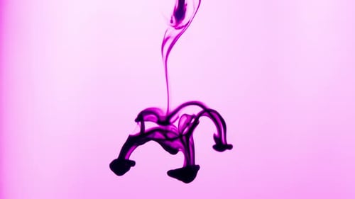 Purple Ink Swirling Against Light Purple Background