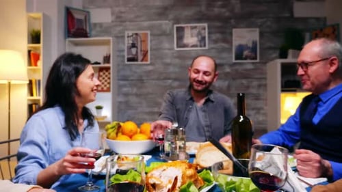 Family Toasting Wine at Dinner Table Celebration
