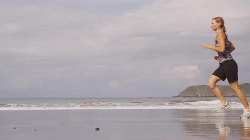 Women running on beach, slow motion. Shot on RED EPIC for high quality 4K, UHD, Ultra HD resolution.