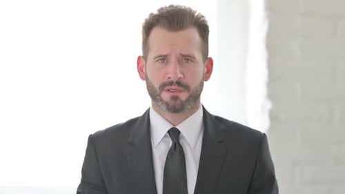 Serious Man in Suit Looking at Camera