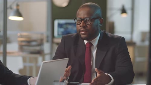 Diverse Male Colleagues Discussing Business at Office Table