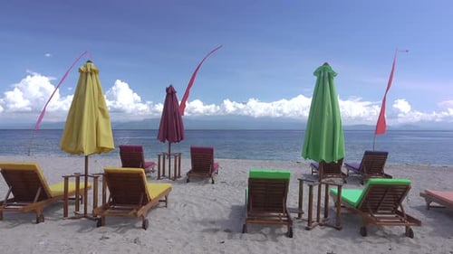 Empty Sunbeds and Umbrellas on the Beach