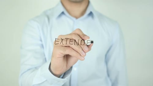 Man Writes Word Extended on Clear Surface