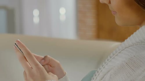 Woman Using Cell Phone Indoors