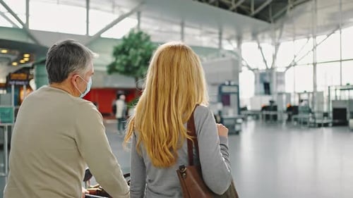 Back View Shot of Couple of Travellers Walking at Airport Building to Terminal Tracking Shot