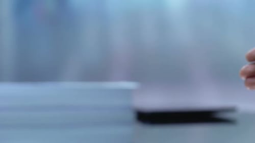 Hand Exchanging Keys with Insurance Tag